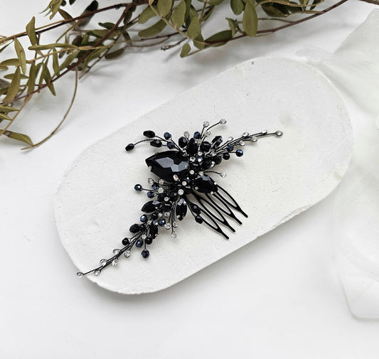 a black and white hair comb on a white plate