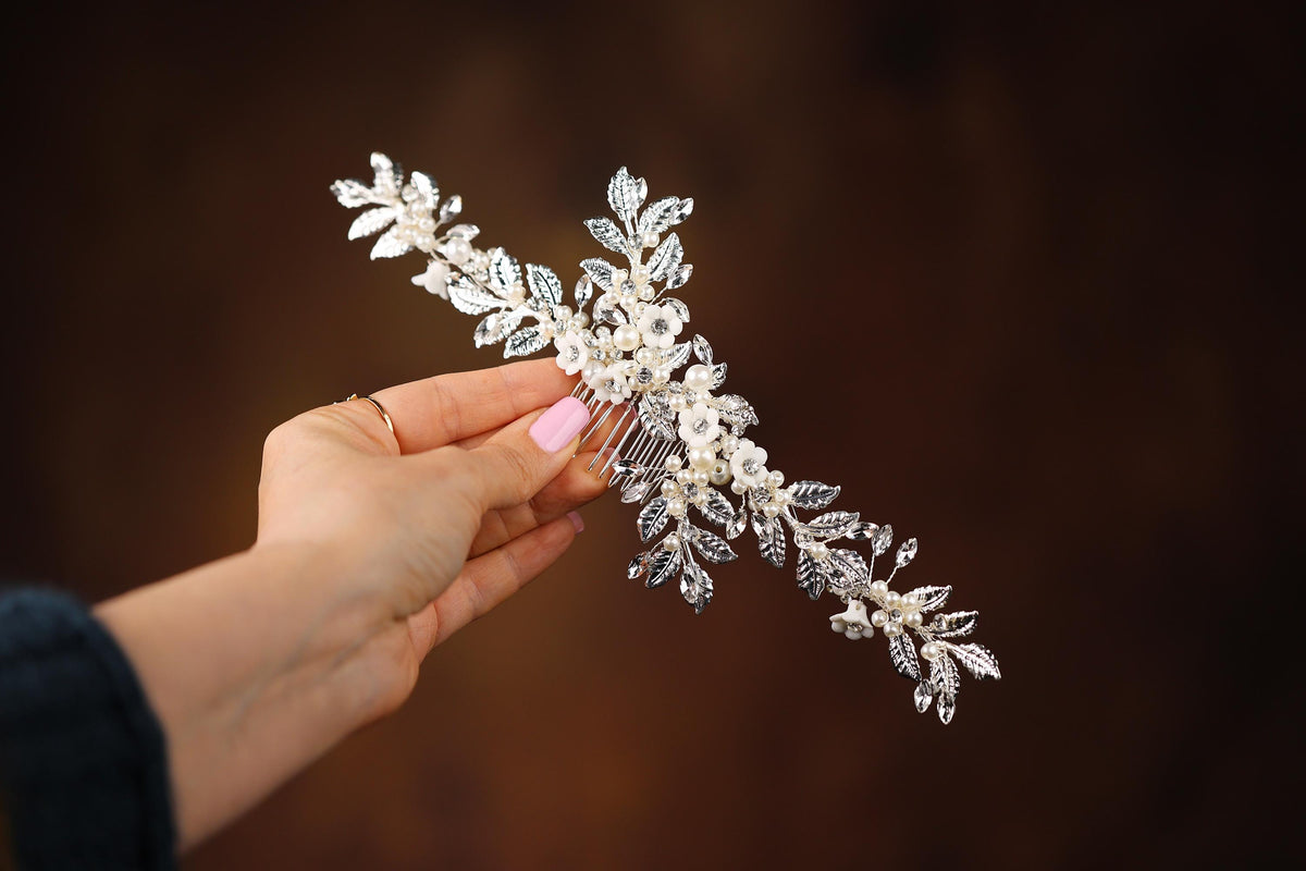 a woman is holding a bridal hair comb