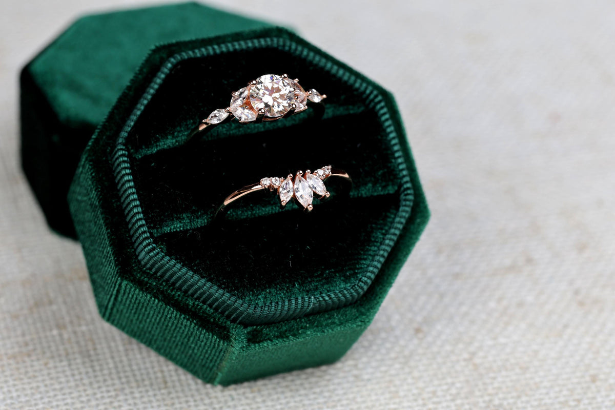 a couple of rings sitting inside of a green box