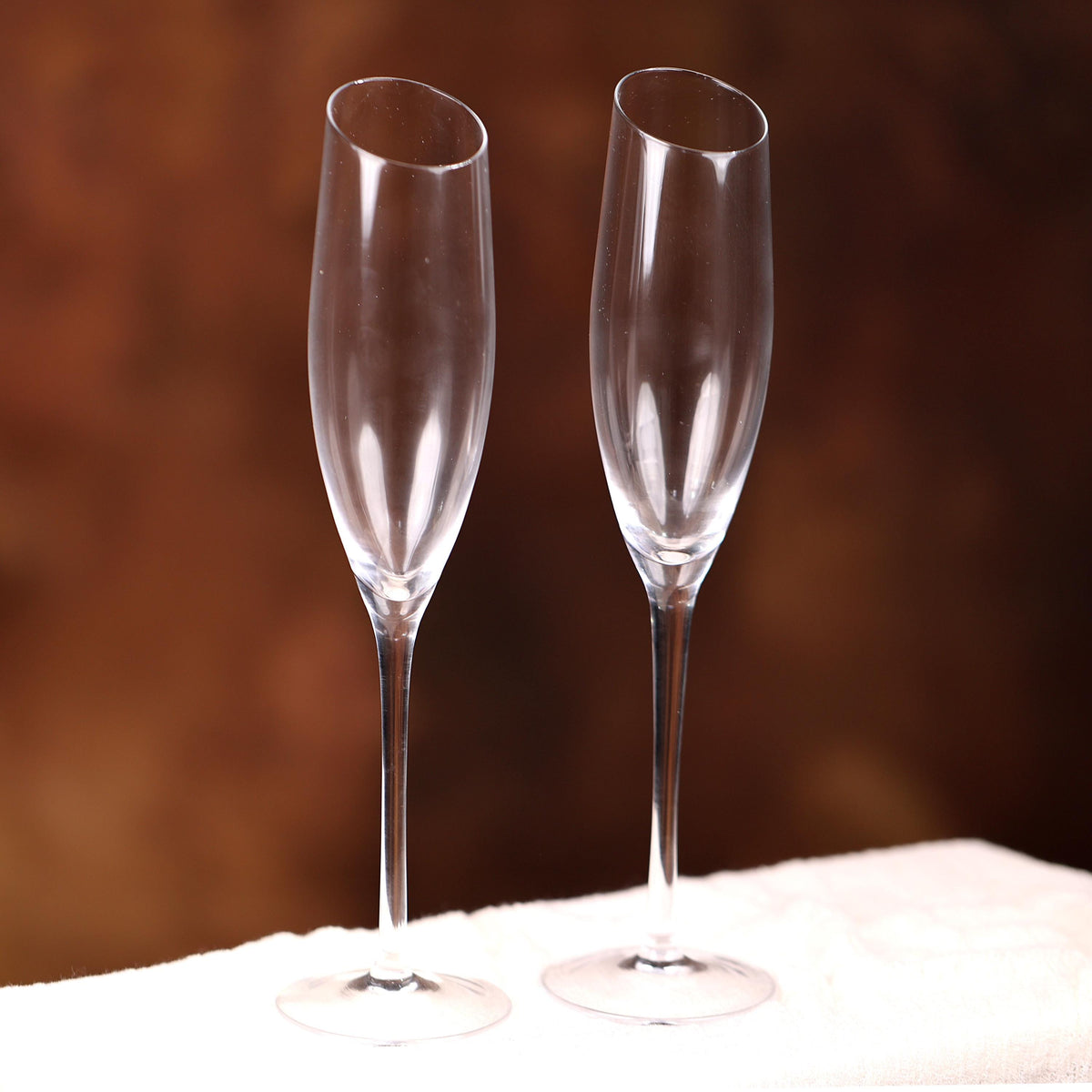 two wine glasses sitting on a white cloth