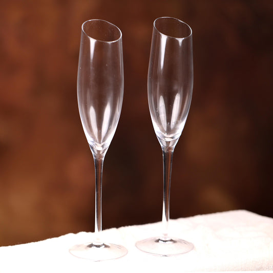 two wine glasses sitting on a white cloth
