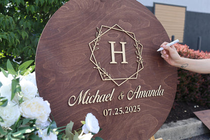a person is writing on a sign in front of flowers