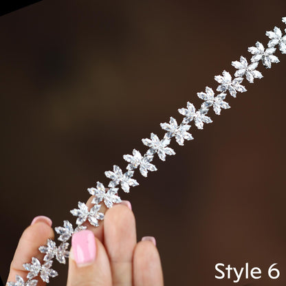 a woman's hand holding a diamond bracelet