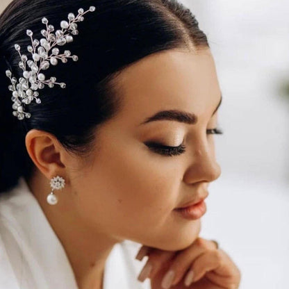 A close-up portrait of a woman with her hair adorned with a decorative hair accessory, showcasing her elegant and poised appearance.