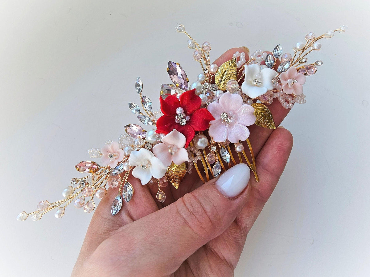 a hand holding a hair comb with flowers on it