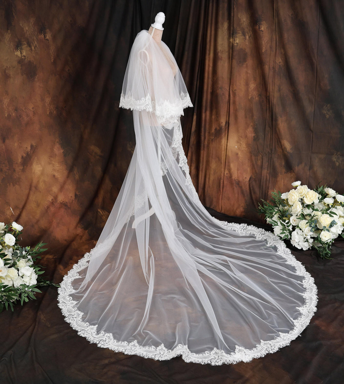 a bridal gown with a veil and flowers