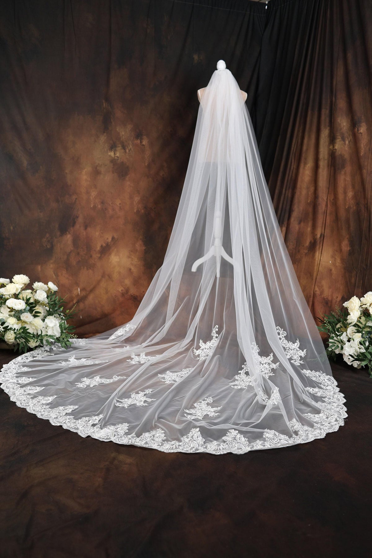 a wedding veil with flowers on a table