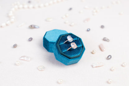 a couple of rings sitting inside of a blue ring box