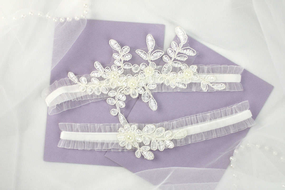 two bridal garters on a purple piece of cloth