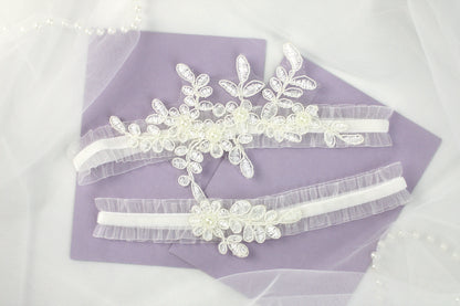 two bridal garters on a purple piece of cloth