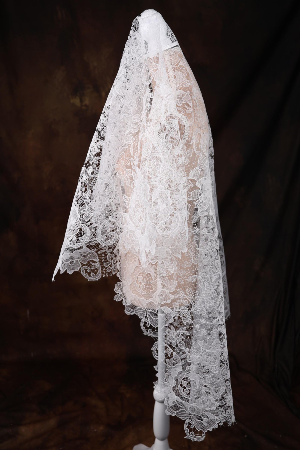 a white mannequin with a white veil on top of it