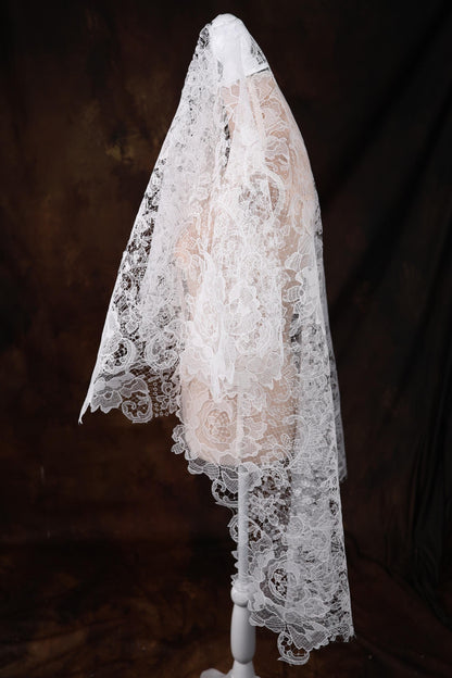 a white mannequin with a white veil on top of it