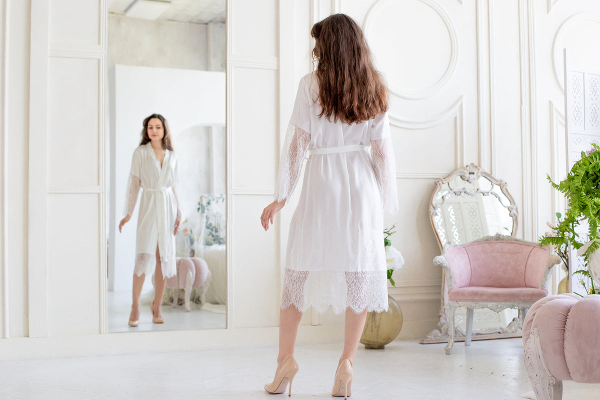 a woman standing in front of a mirror in a room