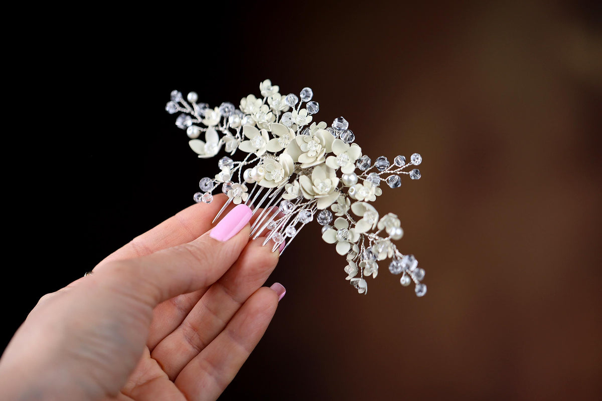 a woman holding a hair comb with flowers on it