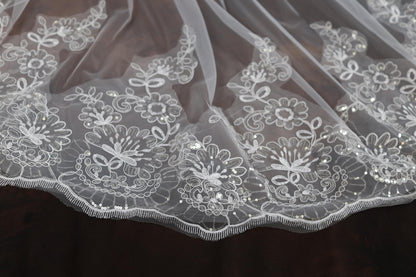 a close up of a white lace on a piece of cloth