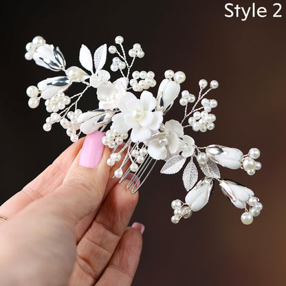 a woman's hand holding a white flower and pearl hair comb