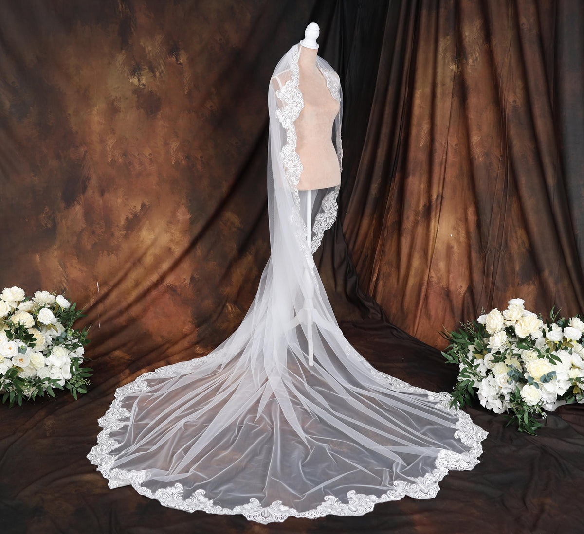 a bridal gown with a veil on a mannequin