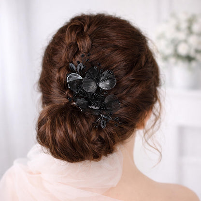 a woman's back view with her hair styled in a bun, adorned with a decorative hair accessory featuring black flowers.
