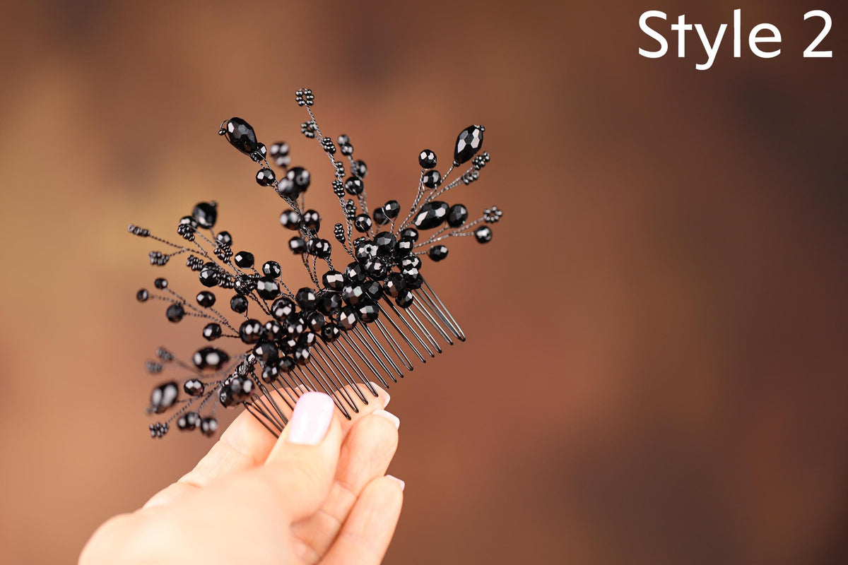 a hand holding a comb with black beads on it