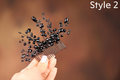 a hand holding a comb with black beads on it