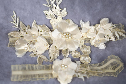 a bridal garter with white flowers and pearls