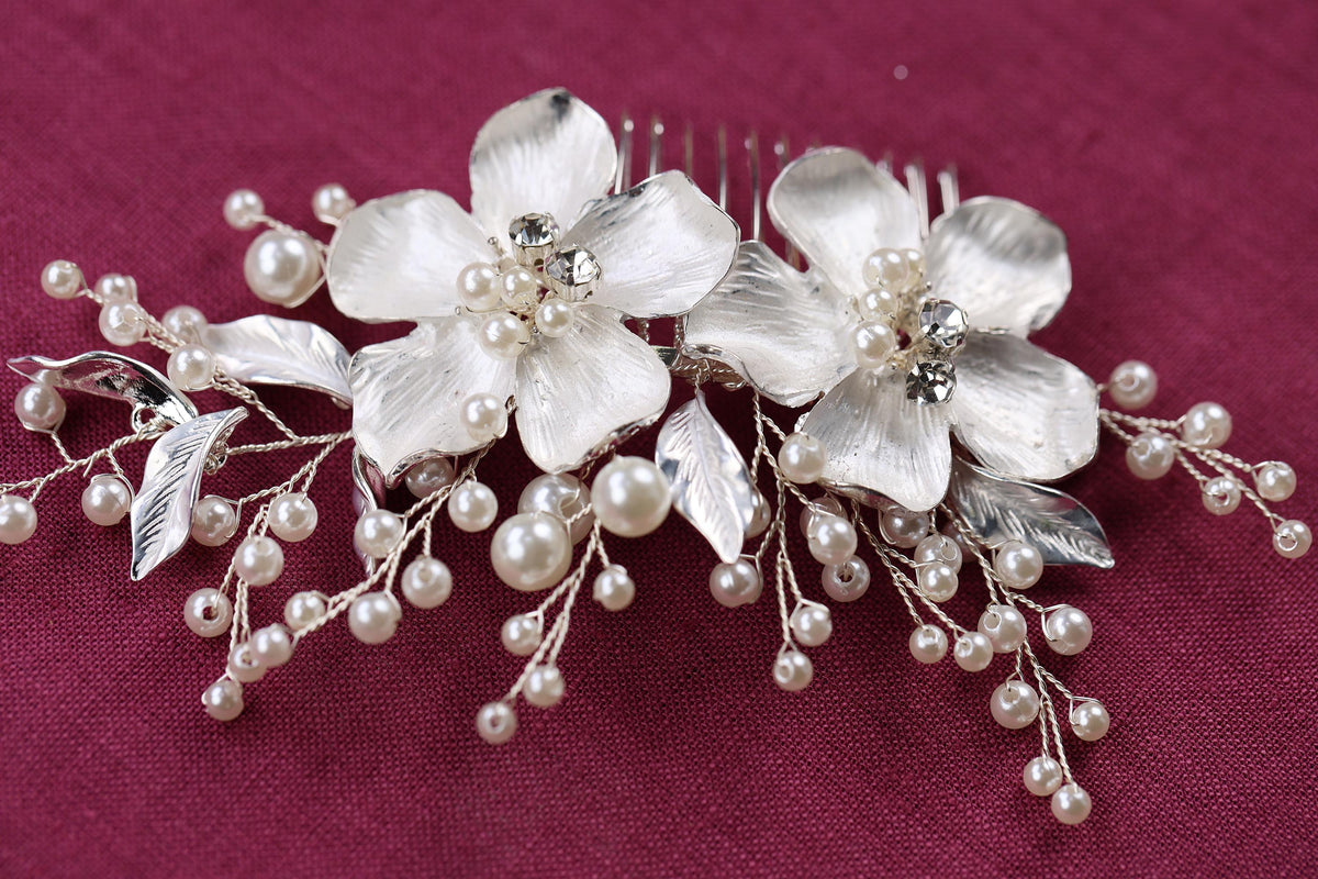 a close up of a hair comb with flowers and pearls