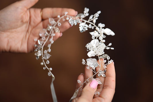 a close up of a person holding a tiara