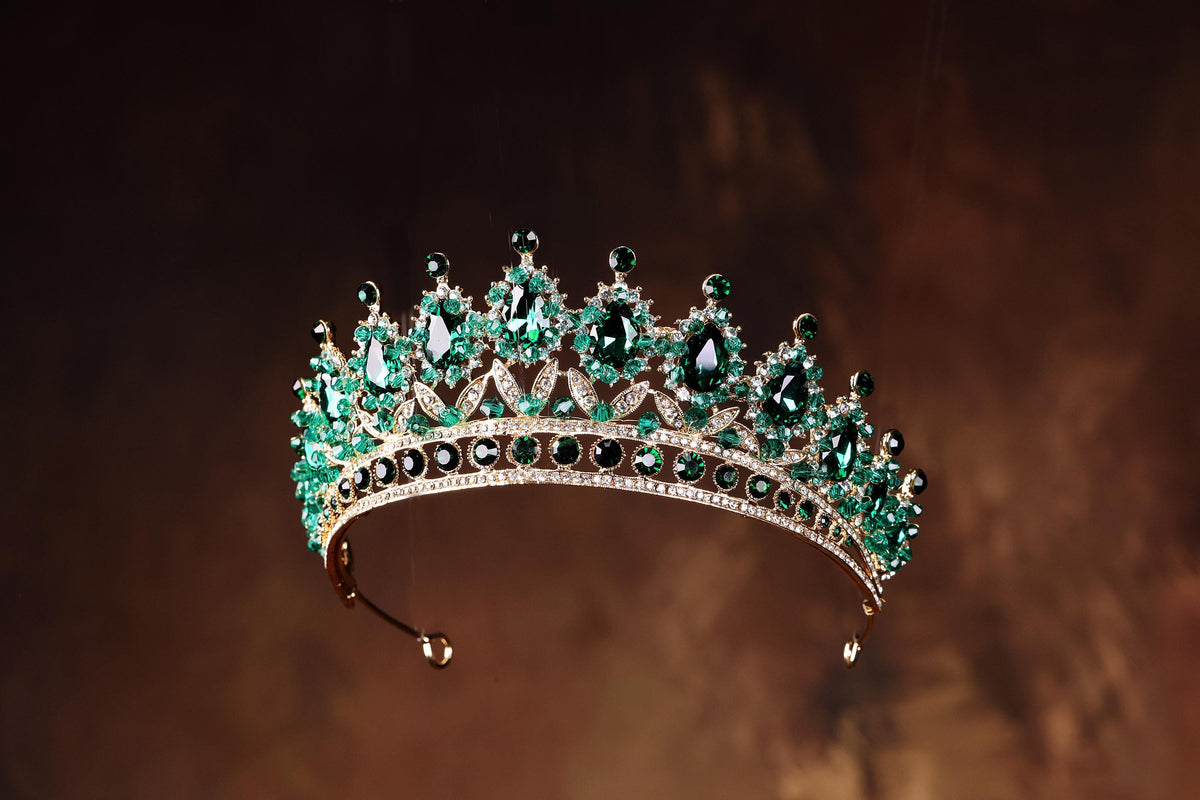 a tiara with a lot of green stones on it