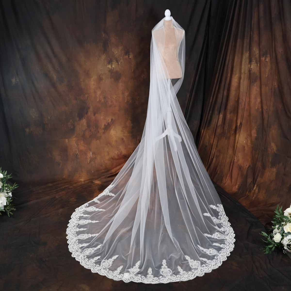a wedding veil on a mannequin with flowers