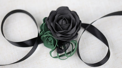 a black rose on a black ribbon on a white background
