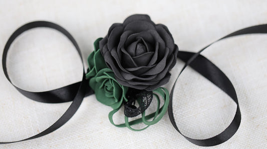 a black rose on a black ribbon on a white background