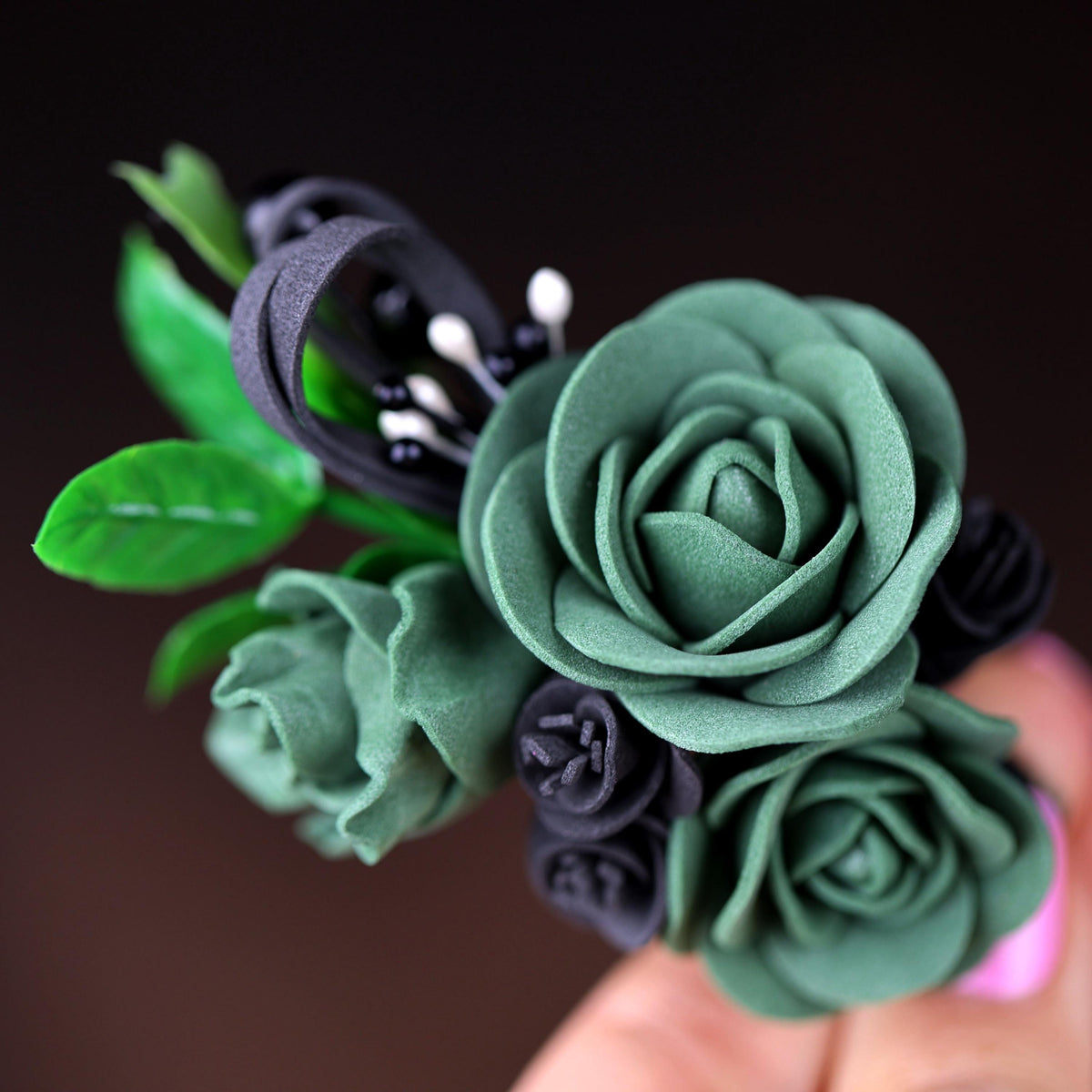 a close up of a person holding a fake flower
