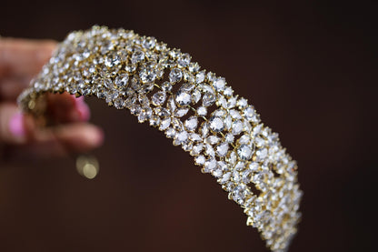a close up of a gold and diamond bracelet