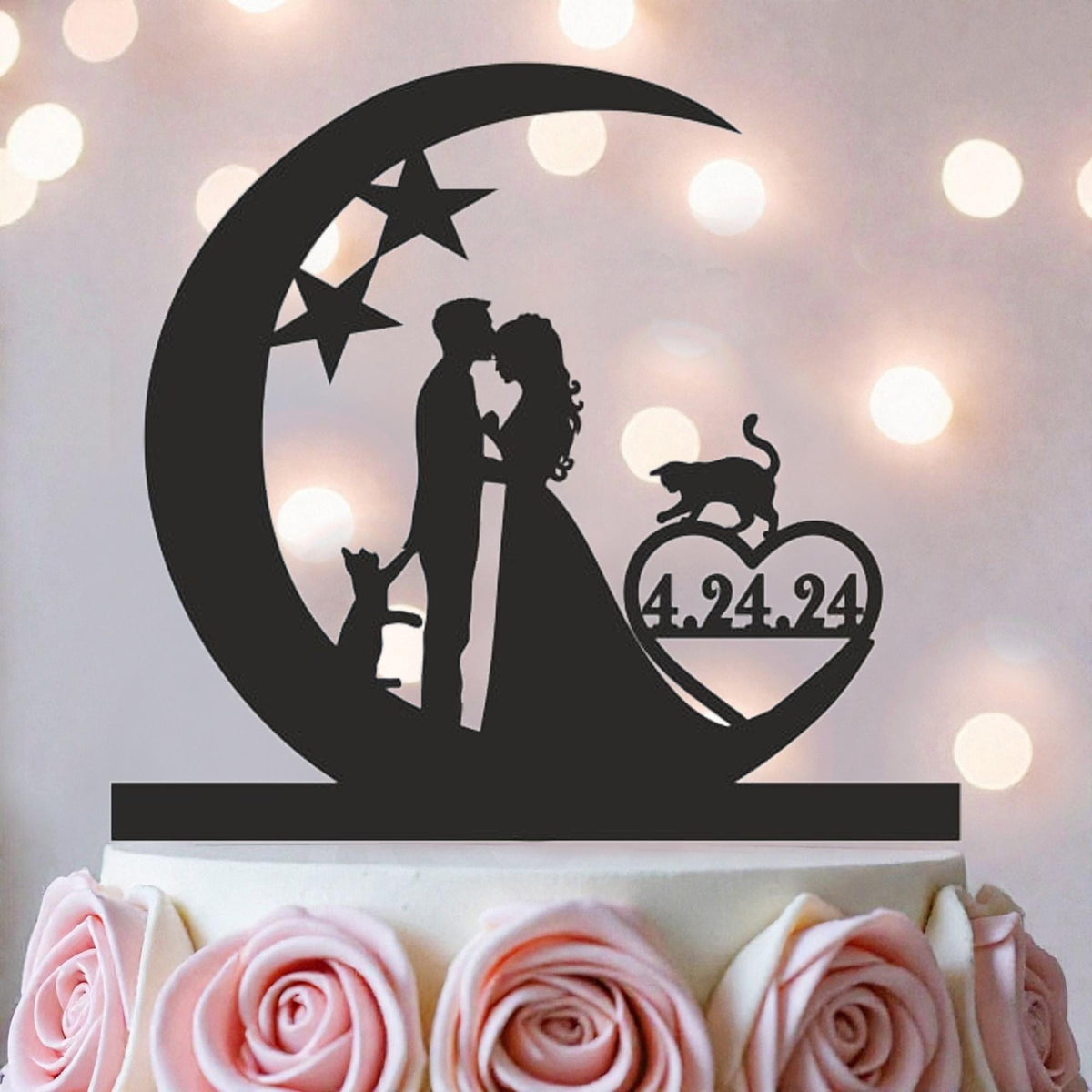 A silhouette of a couple embracing under a crescent moon, with a cat and a heart-shaped symbol with the date "4.24.94" displayed on it, all set against a background of pink roses.
