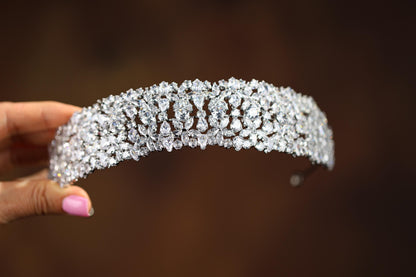 a close up of a person holding a tiara