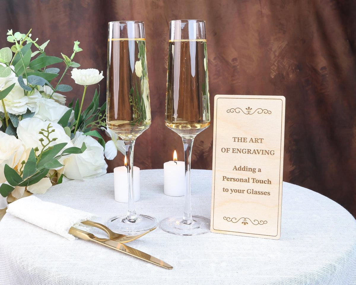 a table with two glasses of wine and a sign