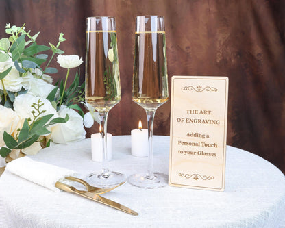 a table with two glasses of wine and a sign
