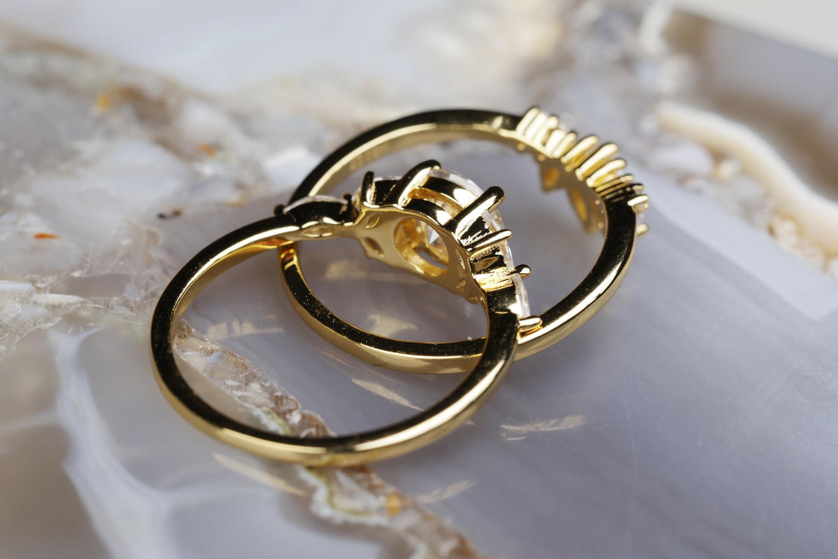 a couple of gold rings sitting on top of a table