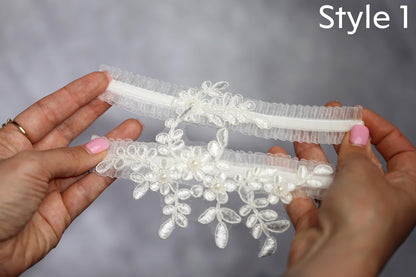 a pair of hands holding a piece of white lace