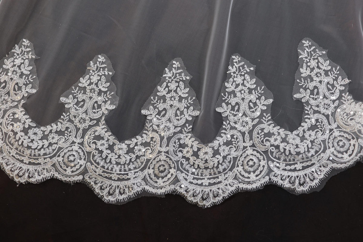 a close up of a white lace on a black background