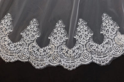 a close up of a white lace on a black background