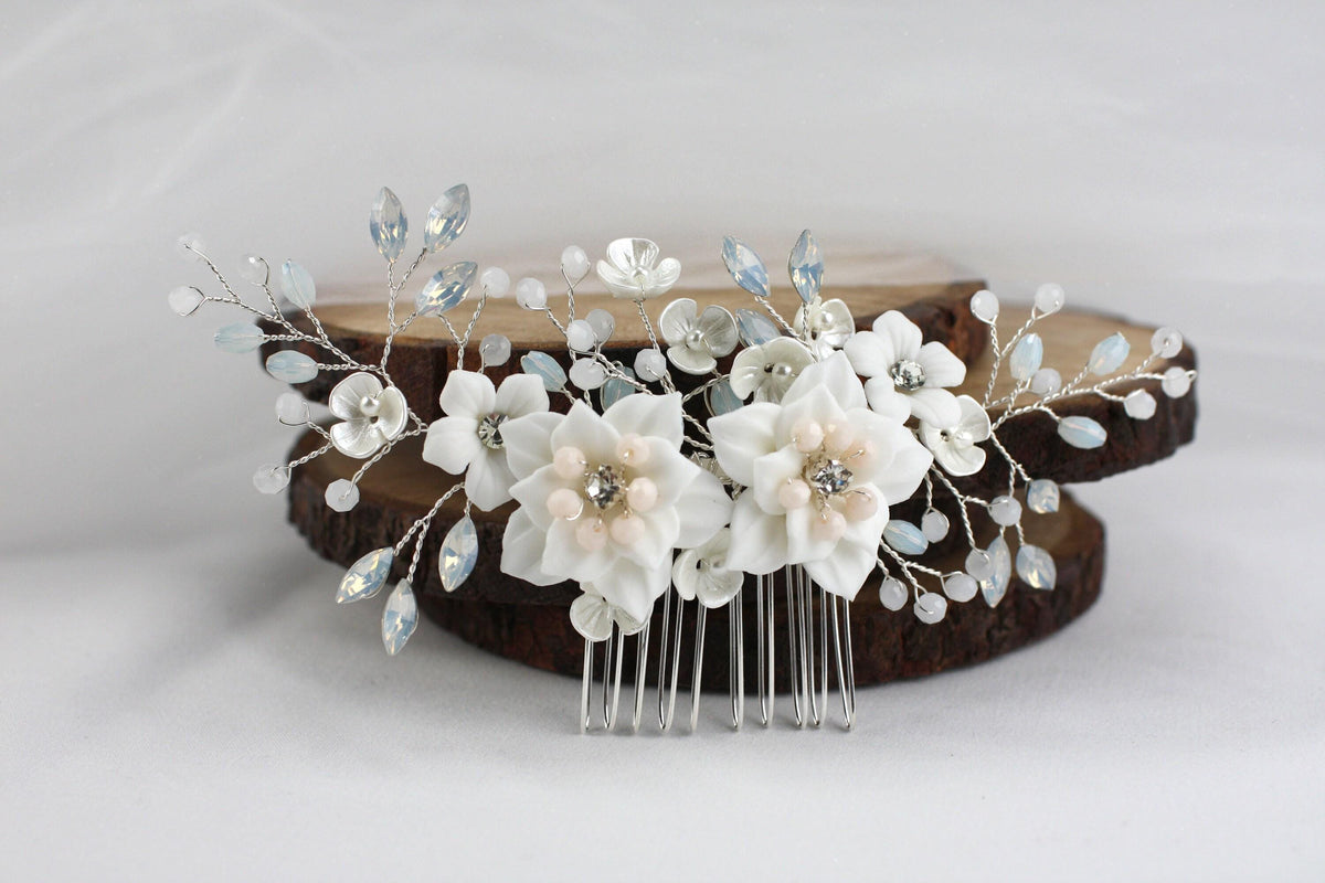 a hair comb with flowers and leaves on it