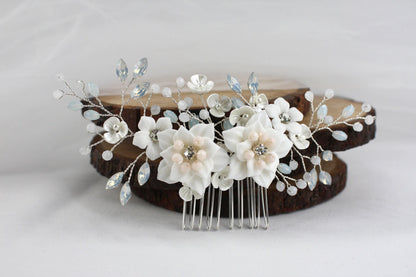 a hair comb with flowers and leaves on it