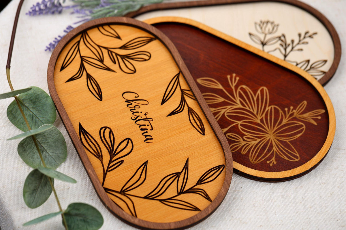 a close up of three wooden plaques on a table