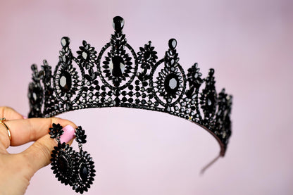 a woman is holding a tiara in her hand