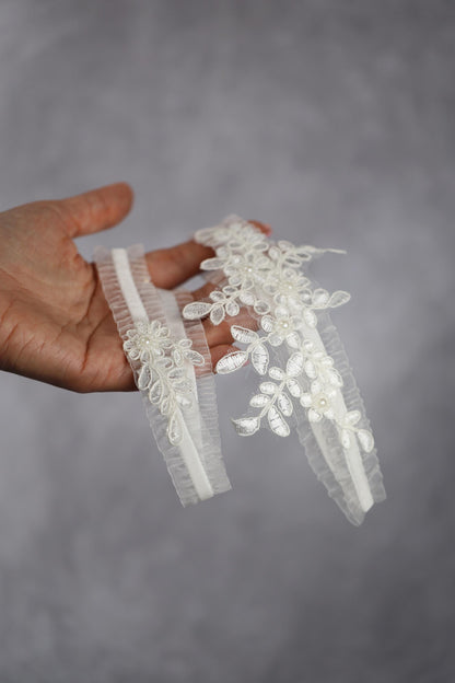 a hand holding a piece of white lace