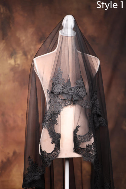 A mannequin wearing a black lace veil with intricate floral patterns, set against a brown background.