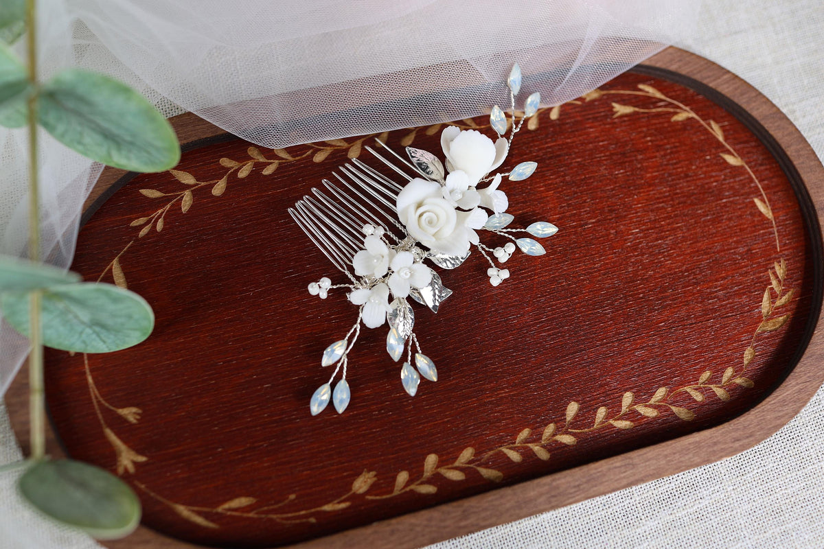 a bridal hair comb with white flowers and leaves