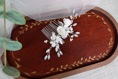 a bridal hair comb with white flowers and leaves
