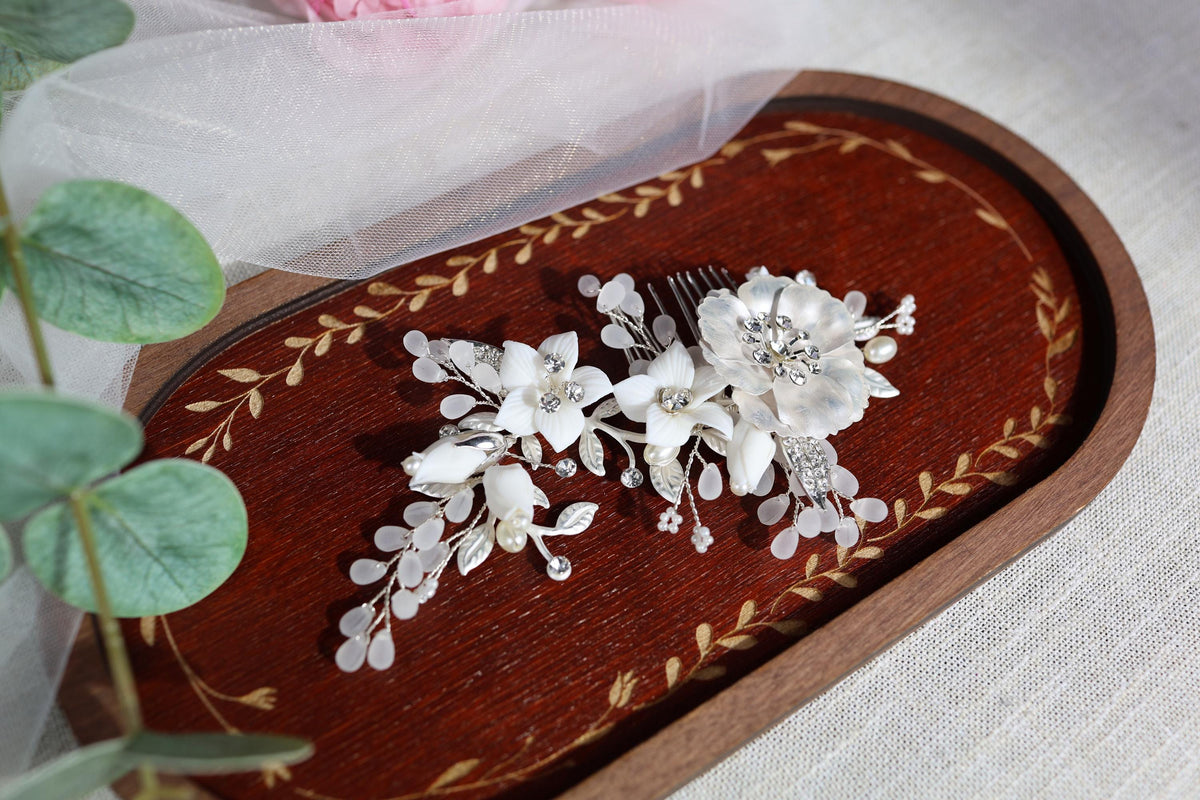 a close up of two flowers on a wooden tray